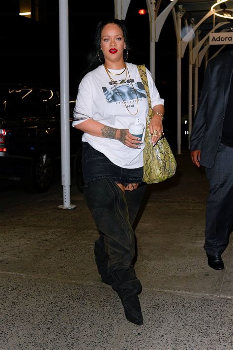 rihanna rocks thigh high boots with a mini skirt while stepping out for