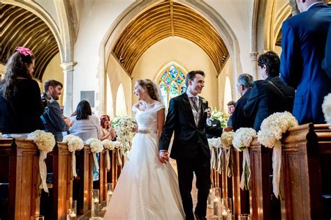 couple walking down the aisle together wedding dresses lace wedding