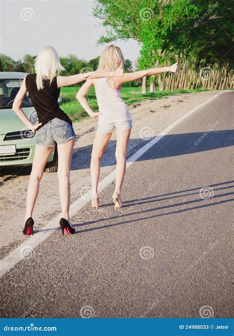 Two Girls Standing Near Car And Hitchhiking Stock Image Image Of Girl