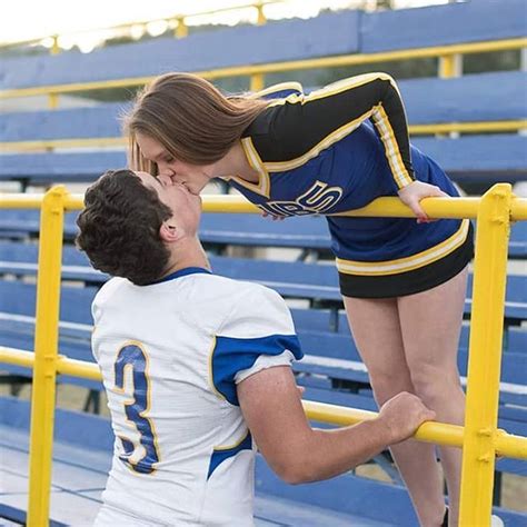 Football Player And Cheerleader Kissing In The Bleachers