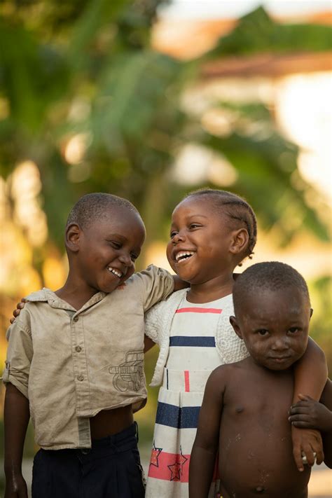 happy african children embracing  street  stock photo