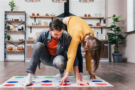 Young Man Playing Twister Game With Her Wife At Home Free Photo