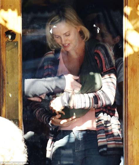 Charlize Theron Cradles A Newborn As She Gets Into Character On Set Of