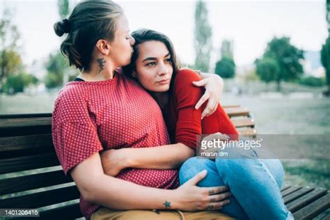 Romantic Lesbian Couple Sitting On Park Bench Photos And Premium High