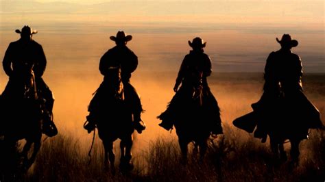 cowboys riding horses  sunset  west desert slow motion hd