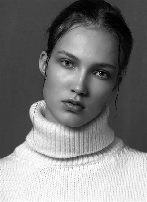 a black and white photo of a woman wearing a turtle neck sweater
