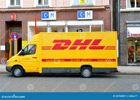 dhl delivery yellow car   street editorial photography image