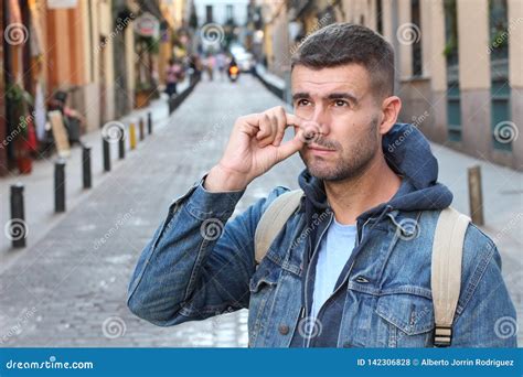 guy picking  nose outdoors stock photo image  human male