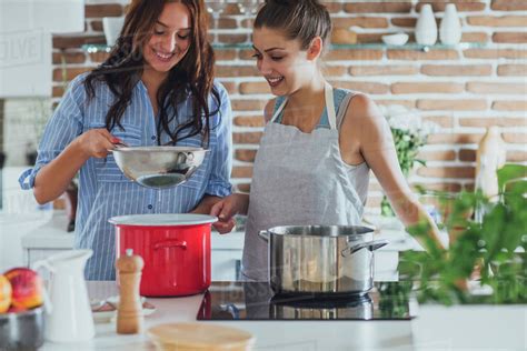 caucasian women cooking  kitchen stock photo dissolve