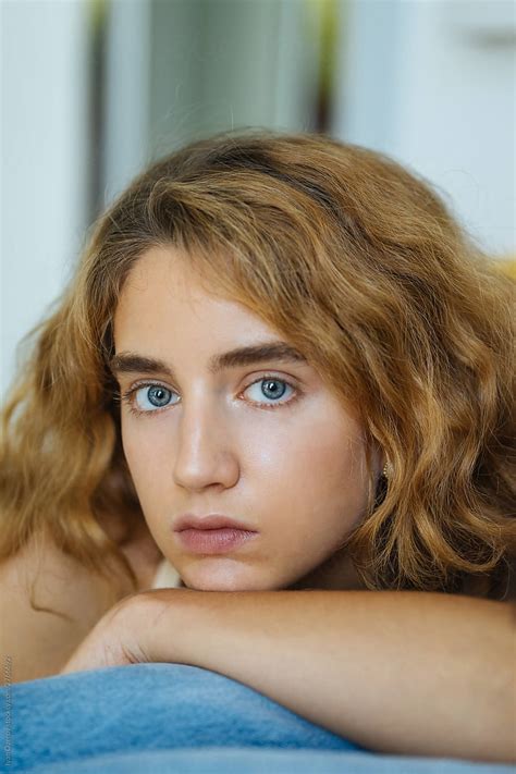 Portrait Of A Beautiful Girl With Wavy Hair And Blue Eyes By Stocksy