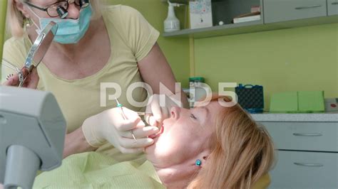 close up view of woman dentist working at her patients