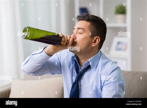 male alcoholic drinking wine  bottle  home stock photo alamy
