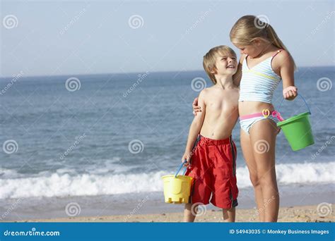boy  girl enjoying beach holiday stock image image  shore