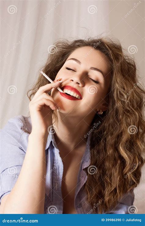 Stylish Emotional Girl With Red Lips And Curly Hair Is Smoking Stock