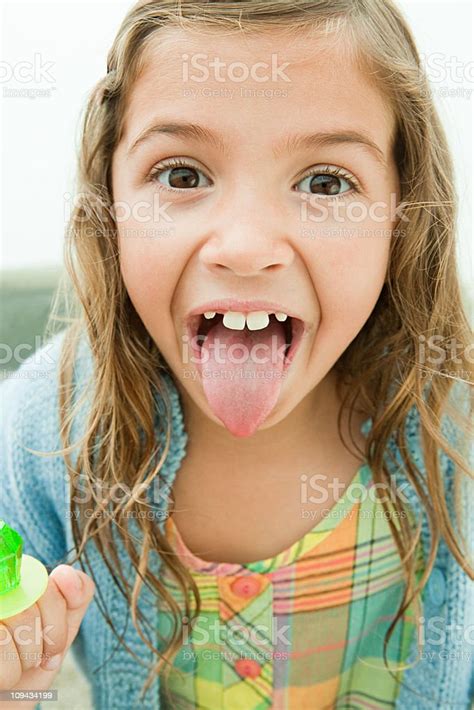 girl sticking out tongue holding lollipop foto stok unduh gambar
