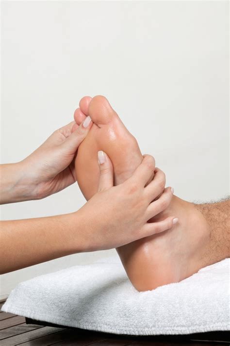Woman Massaging Foot Synergy Spa