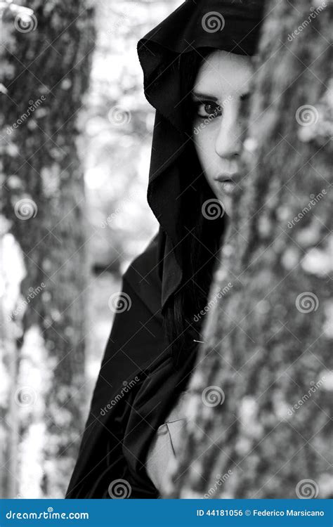 portrait  woman  hood hiding  forest stock photo image