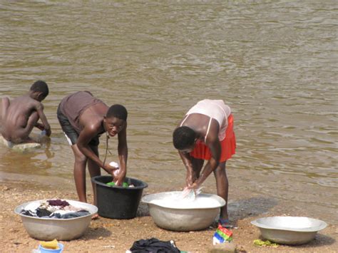 african village women bathing