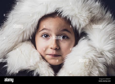 Close Up Portrait Of A Young Girl Dressed With An Eskimo Jacket Looking