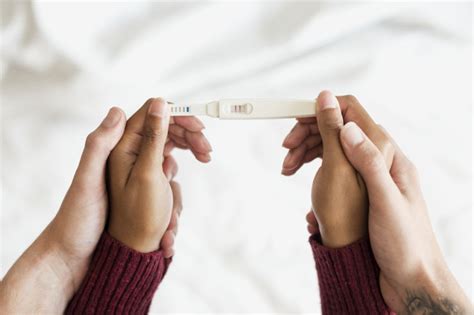 Woman Holding A Positive Pregnancy Test Premium Photo