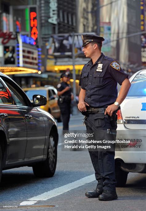 A New York City Police Officer Mans A Checkpoint In Times Square Amid