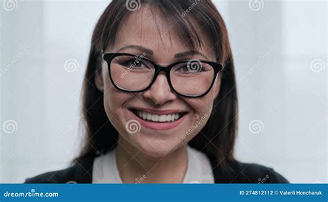 Close Up Face Portrait Of Beautiful Mature Woman With Glasses Smiling