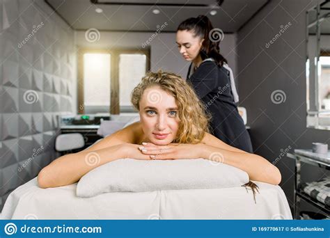 Front View Of Young Female Client Enjoying Relaxing Full Body Massage