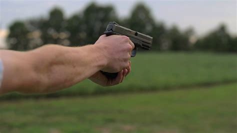 4k 60 Fps Slow Mo Man Fires 44 Mm Hand Gun Slider Shooting Tight Shot
