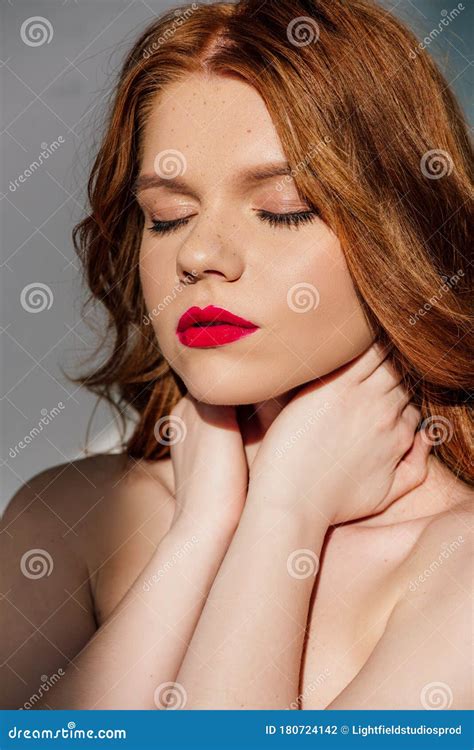 Beautiful Young Seductive Redhead Woman With Red Lips Posing With Eyes
