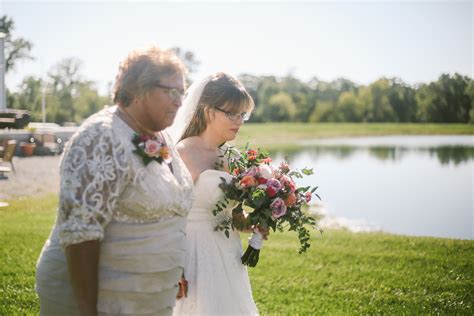 Bride And Mom Walking Down The Aisle From A Boho Barn Wedding In