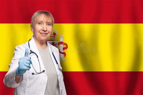 Spanish Smiling Mature Doctor Woman Holding Stethoscope On Flag Of