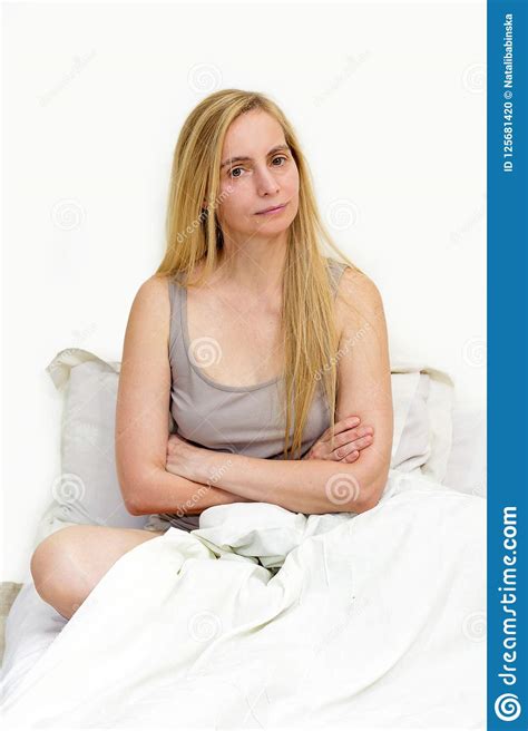 middle age woman real portrait bed bedroom blonde long