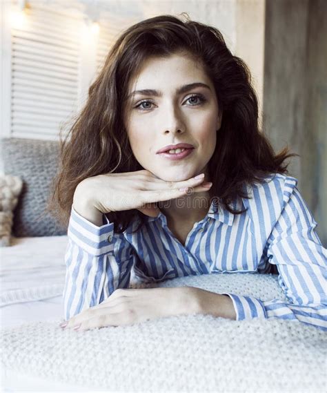 Young Pretty Brunette Woman In Her Bedroom Sitting At Window Happy