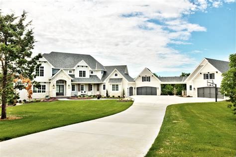 large white exterior detached garage long driveway light colored stone dream house plans