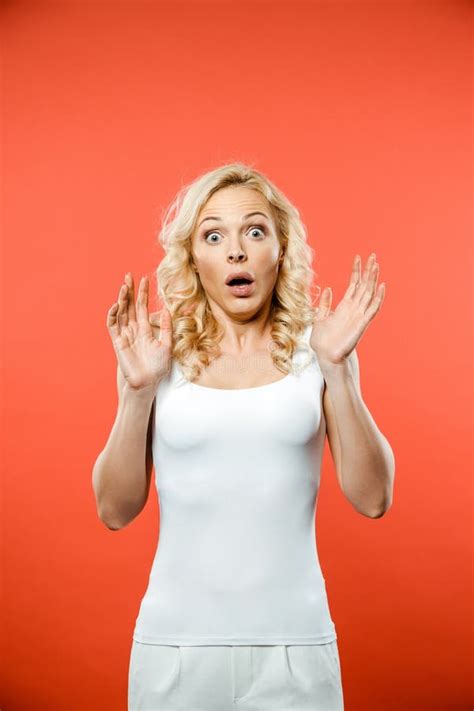 Shocked Attractive Blonde Woman Looking At Camera And Gesturing Stock