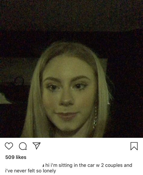 A Woman With Long Blonde Hair Is Looking At The Camera And Has An Instagram
