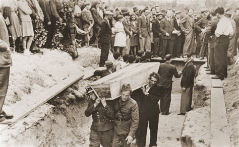 Pallbearers Some Of Whom Are Polish Soldiers Place The Coffins Of The