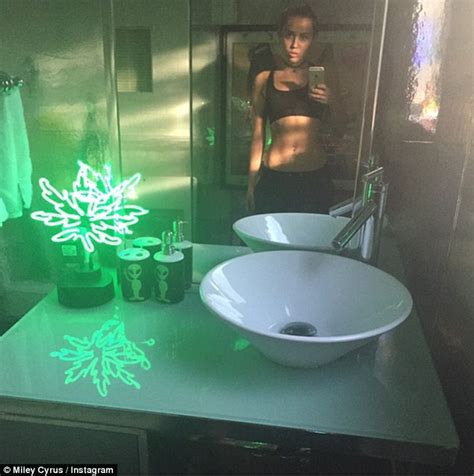 Miley Cyrus Shows Off Her Abs In Another Revealing Mirror