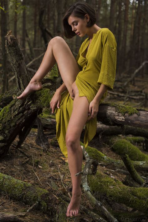 dress wearing short haired brunette exploring nature in the nude
