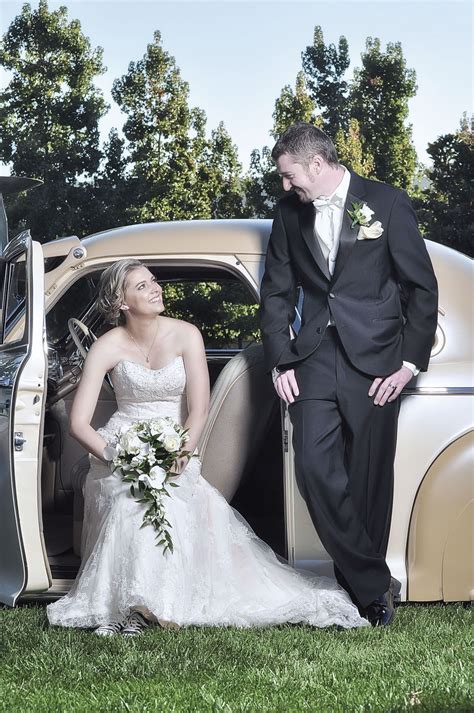 bride and groom posing with a classic car groom poses
