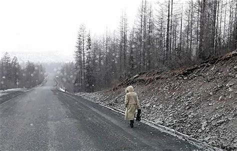 ghostly woman walks slowly along road of bones
