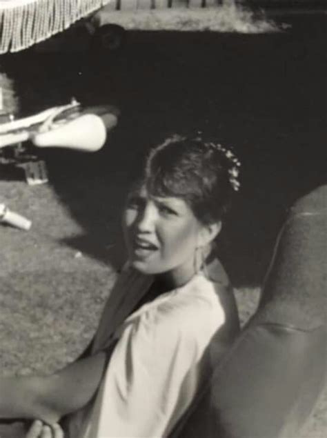 black  white photograph   woman sitting   ground