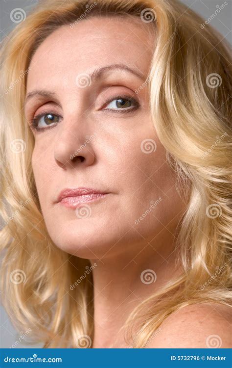 Mature Blond Woman With In Optical Store Trying On Eyeglasses Royalty