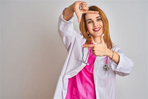 Redhead Caucasian Doctor Woman Wearing Pink Stethoscope Over Isolated