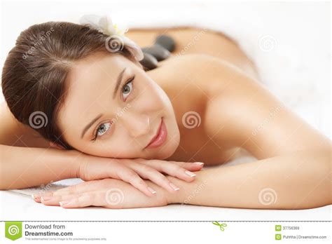 Beautiful Woman Getting Hot Stone Massage In Spa Salon