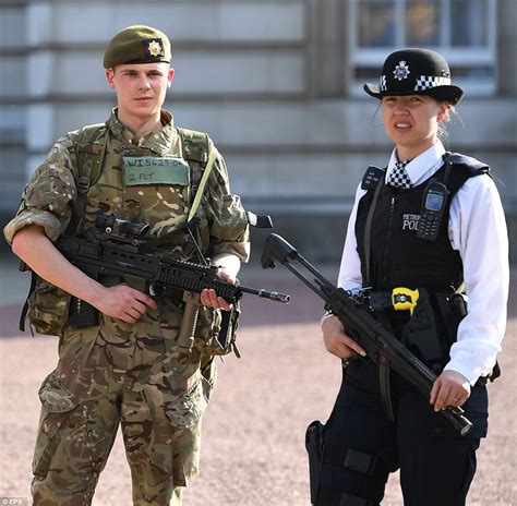 british soldier stands guard    police officer armed soldiers  police officers