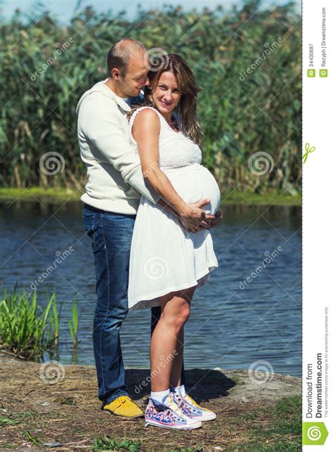smiling husband hugging his pregnant wife stock image image of pregnant belly 34430687