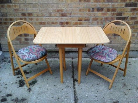 small folding kitchen table   folding chairs  cushions