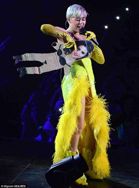 Miley Cyrus Throws Selena Gomez Cutout Into Milan Audience Daily Mail