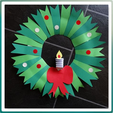 a paper wreath with a lit candle on it